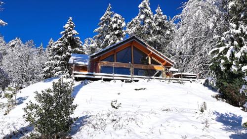 a cabin in the snow with snow covered trees at Le Chalet du Haut du Bout in Fraize