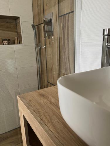 a bathroom with a white sink and a shower at Lmholiday SUNSET apartment in Torre Canne