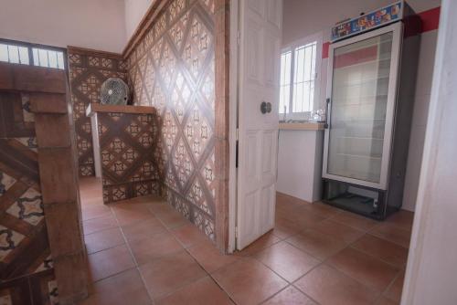 a hallway with a white door and a tile floor at Casa Rural Manuel Sevillano in Bornos