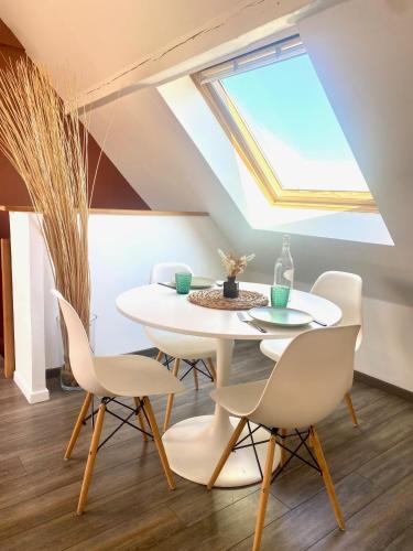 une salle à manger avec une lucarne et une table et des chaises dans l'établissement Calme et cosy - village viticole - route du vin, à Traenheim