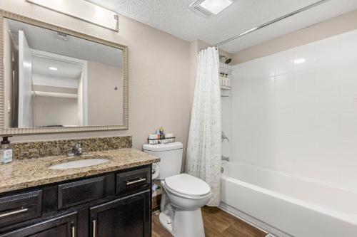 a bathroom with a toilet and a sink and a mirror at Tranquil Haven 2BD 2BA Paradise 10min to Orlando's Best Theme Parks in Orlando