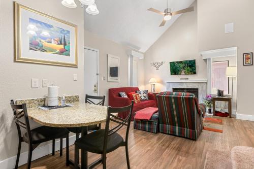 a living room with a table and a couch at Tranquil Haven 2BD 2BA Paradise 10min to Orlando's Best Theme Parks in Orlando
