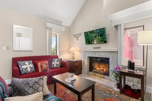 a living room with a red couch and a fireplace at Tranquil Haven 2BD 2BA Paradise 10min to Orlando's Best Theme Parks in Orlando