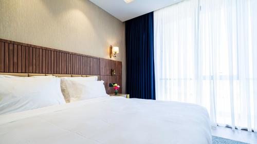 Ένα ή περισσότερα κρεβάτια σε δωμάτιο στο Zind Naaba Appart Hôtel