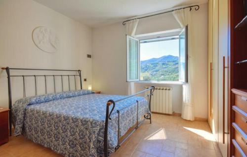 a bedroom with a bed and a large window at Casa L'uliveto in Moneglia
