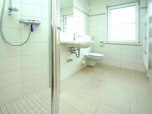 a bathroom with a shower and a sink and a toilet at Apartment by Lake Plau with Stunning Views in Plau am See