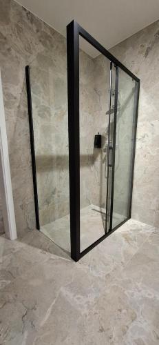 a mirror in a bathroom with a stone wall at Lux GUEST HOUSЕ МUKACHEVO in Mukacheve