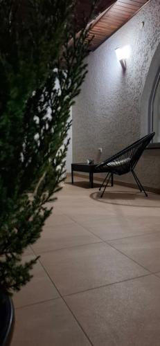 a black bench in a building with a table at Lux GUEST HOUSЕ МUKACHEVO in Mukacheve