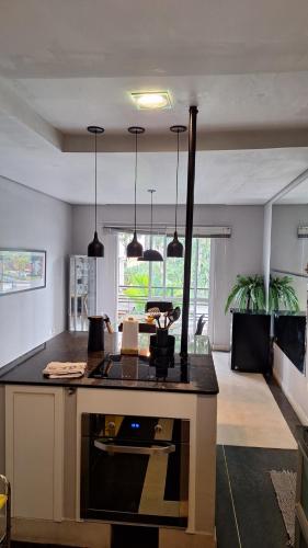 a kitchen with a island with a stove top oven at Casa Alto Da Boa Vista Com Piscina e Churrasqueira in São Paulo