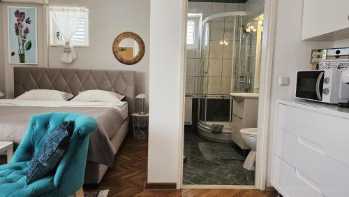 a small bedroom with a bed and a bathroom at Adria Apartments and Rooms in Dubrovnik