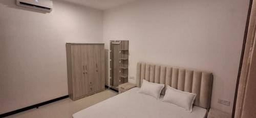 a bedroom with a bed with white sheets and pillows at The Anchorage Grand Colombo AT TRI-ZEN COLOMBO 02 in Colombo