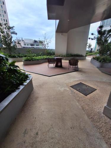 a patio with two benches and a table in a building at The Anchorage Grand Colombo AT TRI-ZEN COLOMBO 02 in Colombo