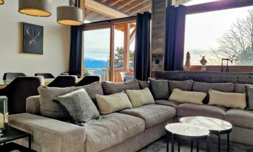 a living room with a large couch and large windows at Loft Odette in Font Romeu Odeillo Via
