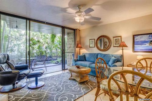 a living room with a blue couch and a table at Awesome Paki Maui Beach condos in Lahaina in Lahaina