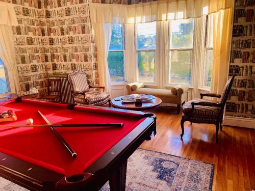 a living room with a red pool table in it at The Langworthy Inn & Winery in Westerly