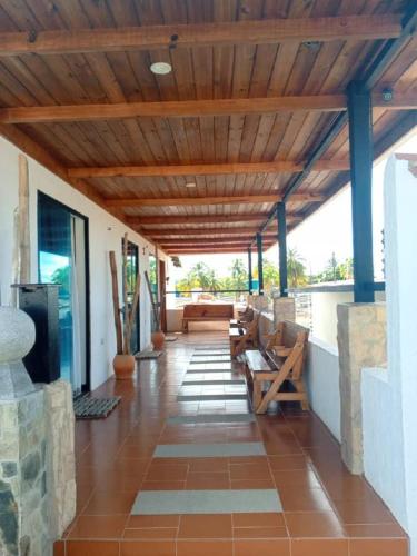 a living room with a wooden ceiling and a patio at Tu escapada en Chichiriviche Venezuela in Chichiriviche