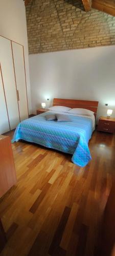 a bedroom with a bed with a blue comforter at Urban 34 - station & centre in Treviso