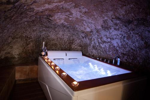 a bathroom with a tub with lights around it at Tower Cottage in Isola del Liri