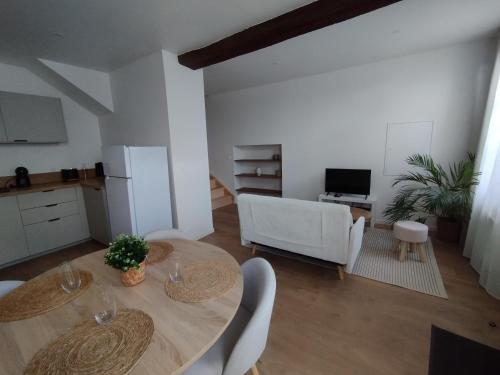 a kitchen and dining room with a table and chairs at Duplex en bord de Loire in Saint-Martin-de-la-Place
