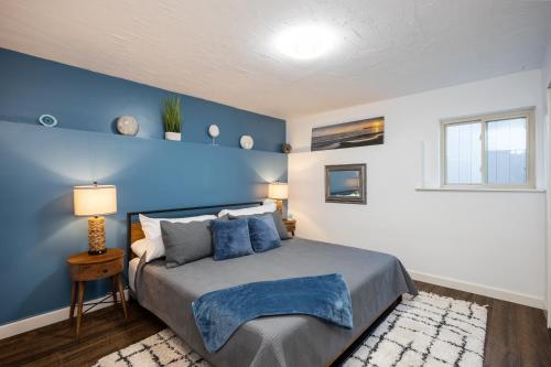 a bedroom with a blue accent wall and a bed at Cozy One-Bedroom Coastal Retreat - Walk to Beach in El Granada