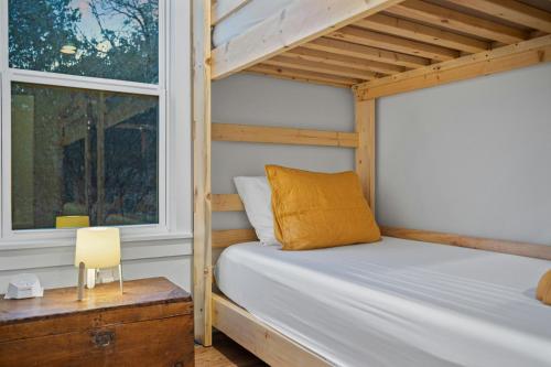 a bedroom with a bunk bed and a window at The Clifftop Perch, 70ft above the dry Blanco in Wimberley
