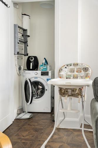 a laundry room with a washing machine and a table at 1 Cathedral Place - Cathedral Townhouses Cobh in Cobh
