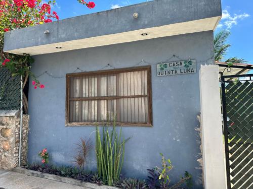 a building with a window and a sign on it at Casa Quinta Luna in Homún