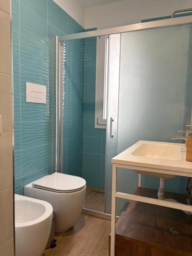 a bathroom with a toilet and a sink and a shower at La Casa di Nonna Maria in SantʼAmbrogio