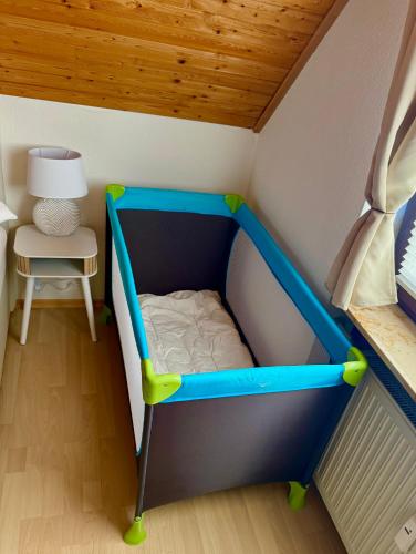 a toy bed in a doll house with a table at Surki's Loggia an der Sonne in Schluchsee