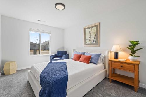 a bedroom with a bed and a table and a chair at Spacious 6BR - Sleeps 22 - Game Room & Pool Access in Meridian
