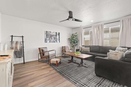a living room with a couch and a table at Spacious 6BR - Sleeps 22 - Game Room & Pool Access in Meridian