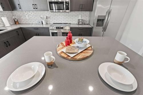 a kitchen with two white plates on a table at Spacious 6BR - Sleeps 22 - Game Room & Pool Access in Meridian