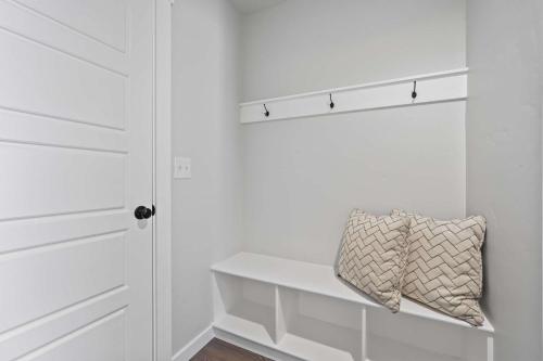 a white closet with a white door and a pillow at Spacious 6BR - Sleeps 22 - Game Room & Pool Access in Meridian