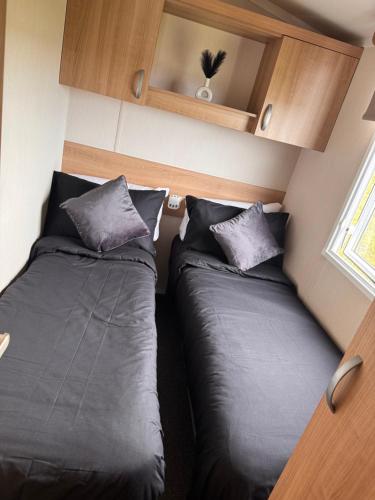 two beds in a small room withermottermottermott at 107 Arran View with WiFi in Ayr