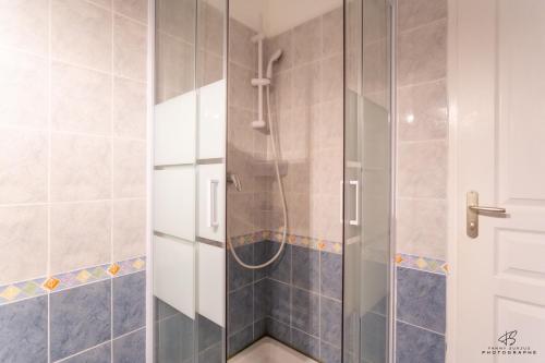 a shower with a glass door in a bathroom at La Terrasse d'Azur - Vue sur la mer in Lapalme