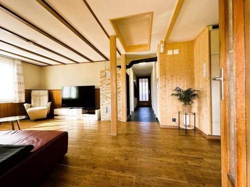 a living room with a couch and a television at Time out near Lake of Thun & Emmental region in Fahrni