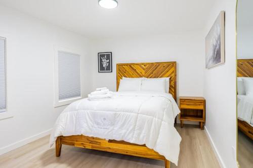 a bedroom with a large bed with a wooden headboard at Luxury 2 Bed 2 Bath East Boston in Boston