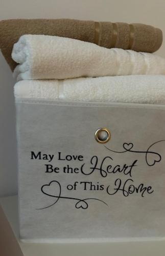 a towel with the words may love be the least of this home at APARTMENT CENTRAL No 5 in Apatin
