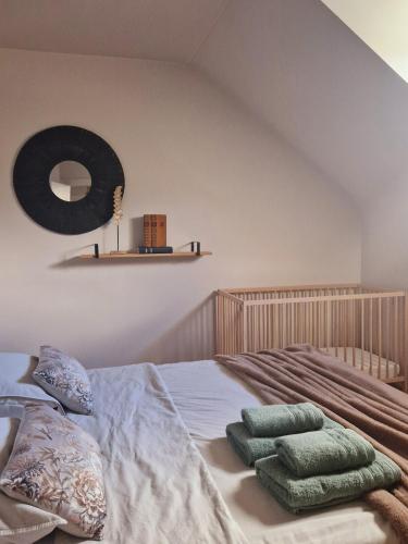 a bedroom with a bed with green pillows on it at La Maison des Petits Bonheurs in Rixheim