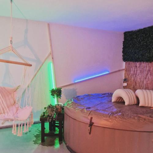 a room with a bed and a chair in it at La Maison des Petits Bonheurs in Rixheim