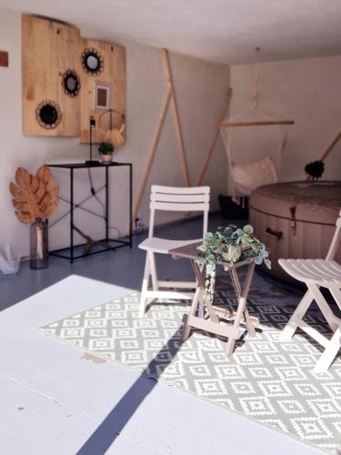 a living room with two chairs and a table at La Maison des Petits Bonheurs in Rixheim