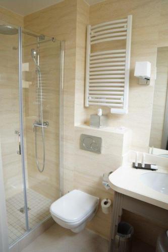 a bathroom with a shower and a toilet and a sink at Hotel Residence Foch in Paris