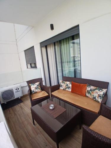 a living room with a couch and chairs and a table at Ocean Park Zenata City Eco in Casablanca