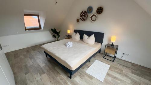 a bedroom with a large bed with white sheets and pillows at Design Penthouse im alten Schloss Deidesheim in Deidesheim