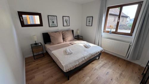 a bedroom with a bed with two towels on it at Design Apartment im alten Schloss Deidesheim in Deidesheim