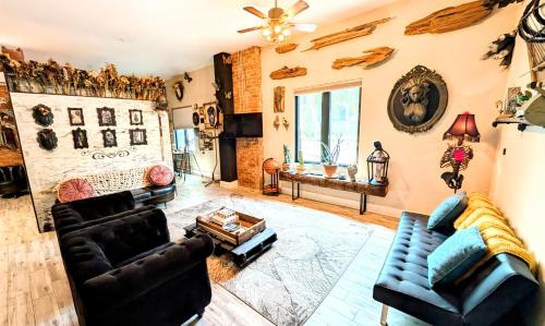 a living room with two couches and a fireplace at Cozy AF Gothic Rose Gallery in Tampa