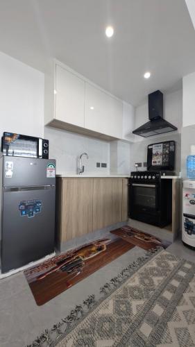a kitchen with a stove and a sink at Forest View - Lavington in Nairobi