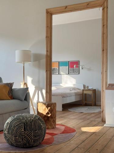 a living room with a bed and a couch at Stepono Apartment in Vilnius
