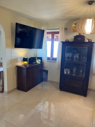 a living room with a large flat screen tv on the wall at Villa Yari in Lovran