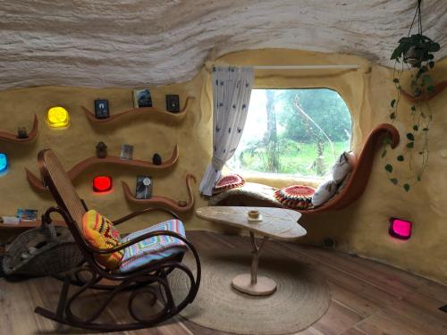 une chambre avec deux chaises et une table dans une grotte dans l'établissement Maisonnette Kerterre en Bretagne, à Caudan